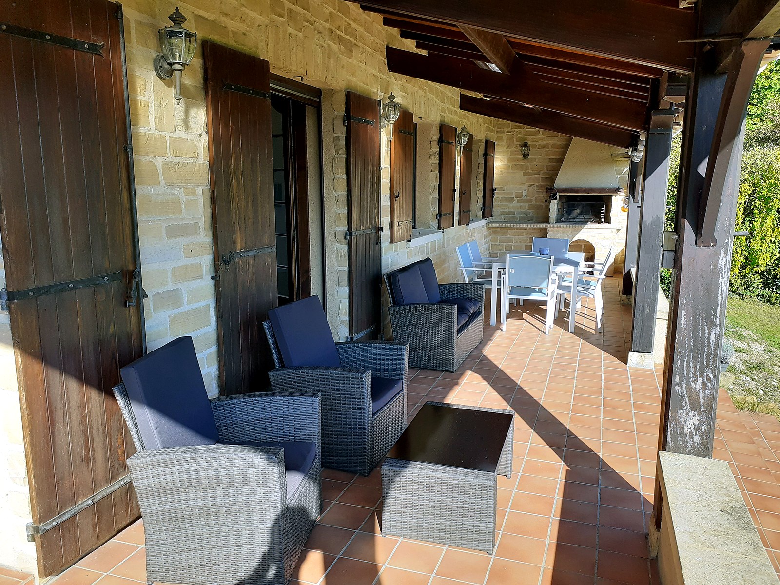 Covered terrace seating, dining area and BBQ