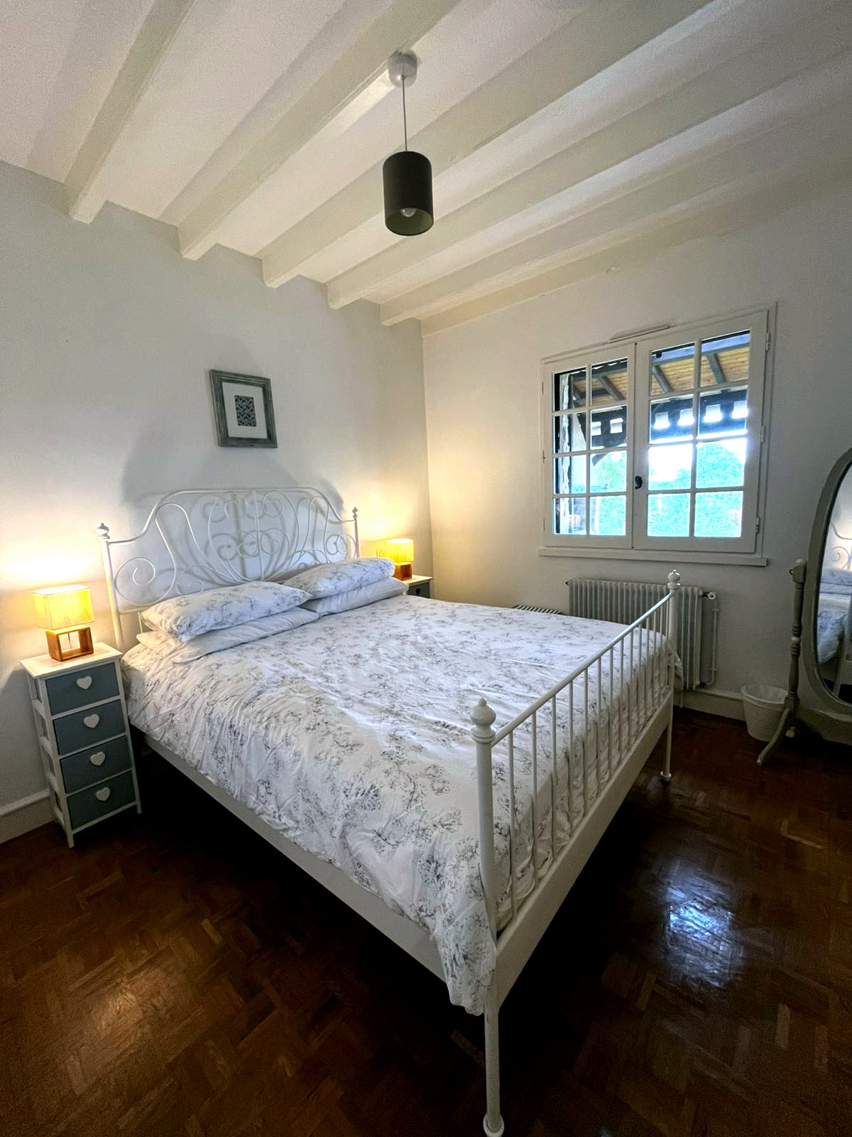 Second bedroom with king size bed and bedside lamps